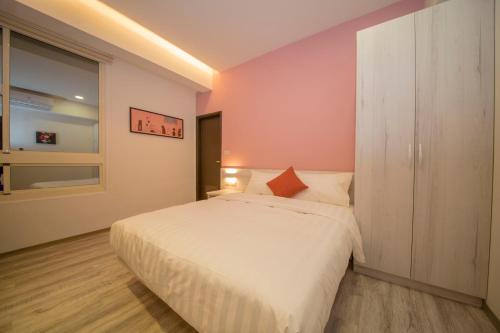 a bedroom with a white bed and a window at 177 Guest House in Nantou City