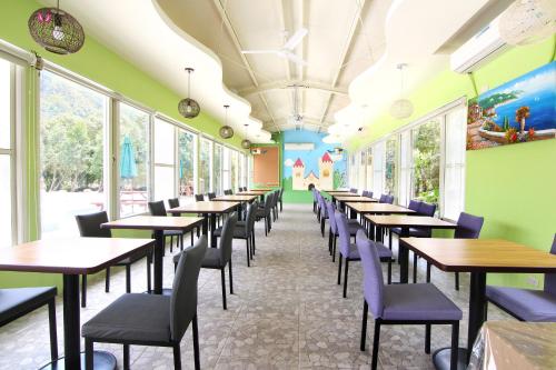 a row of tables and chairs in a restaurant at Magnni Villa in Nanzhuang