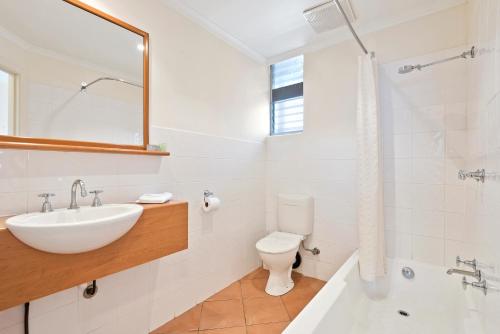 a white bathroom with a sink and a toilet at North Pier Hotel in Cowes