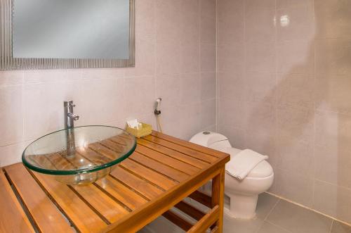 a bathroom with a glass sink and a toilet at Krabi Home Town Boutique in Krabi town