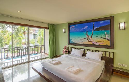 a bedroom with a bed with a large painting on the wall at Krabi Home Town Boutique in Krabi town