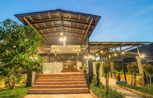 a building with stairs leading up to it with lights at Krabi Home Town Boutique in Krabi town
