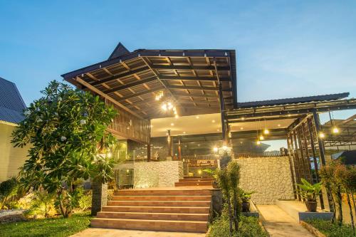 a house with a staircase in front of it at Krabi Home Town Boutique in Krabi town