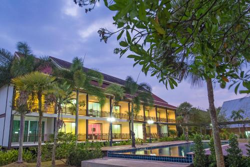 a building with a pool in front of it at Krabi Home Town Boutique in Krabi town