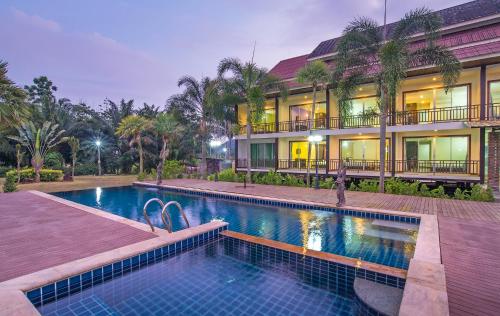 a house with a swimming pool in front of a building at Krabi Home Town Boutique in Krabi town