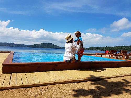 a woman and a boy standing on a dock at Mystic Sands in Utungake