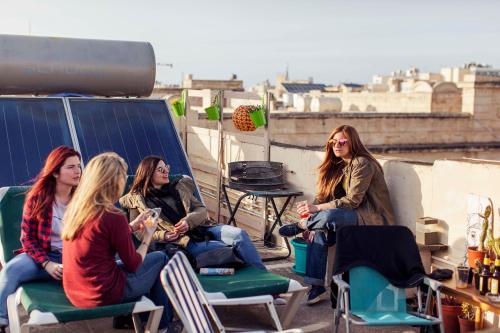 a group of women sitting on a roof at Granny's Inn Hostel in Sliema