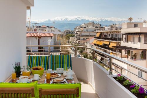 a table on a balcony with a view of a city at Stefan's Penthouse in Chania