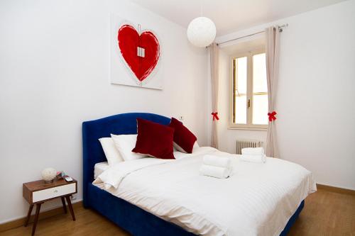 a bedroom with a bed with a red heart on the wall at Ciao Bella Stella in Rome