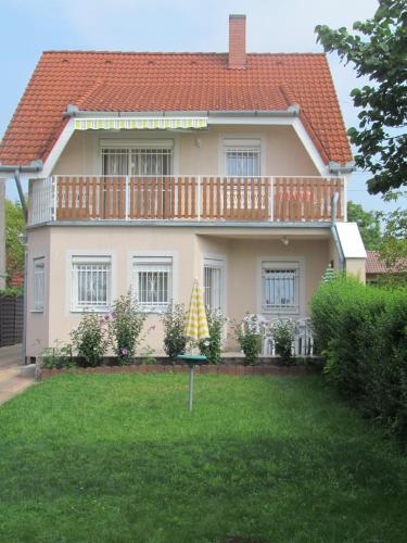 a large house with a large yard in front of it at Lili nyaralóház in Gyenesdiás