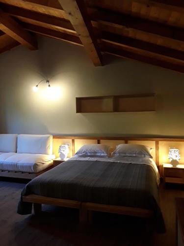 a bedroom with a large bed and a couch at Sostio a Levante in Framura