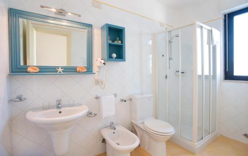 a bathroom with a toilet, sink, and shower at Hotel Del Levante in Torre Canne