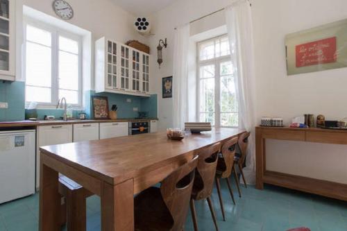 a kitchen with a large wooden table and chairs at Brand New Gem In Talbiyeh in Jerusalem