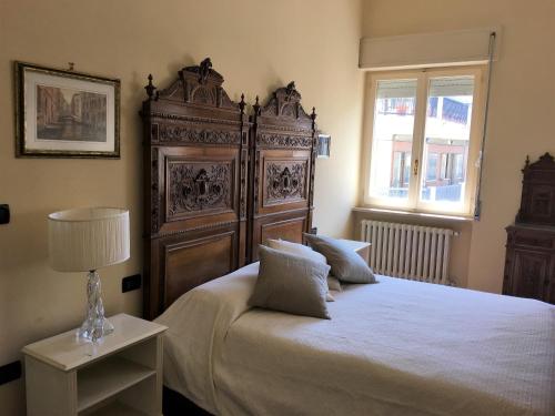 a bedroom with a large bed with a large wooden headboard at Attico vista mare in Pescara