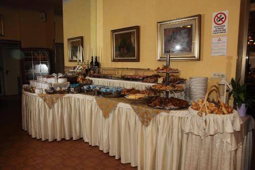 a table with a buffet of food on it at Hotel Diana in Grado