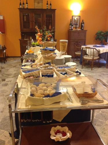a table with food on it in a room at Aer Hotel Malpensa in Oleggio