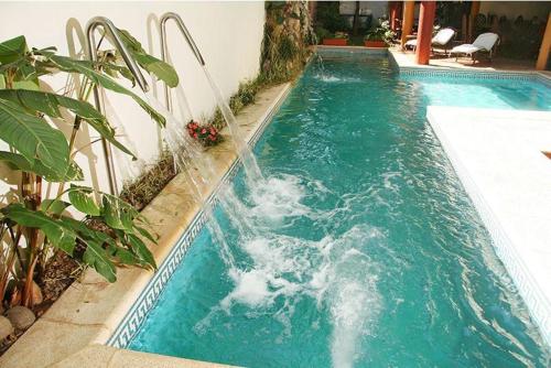 a swimming pool with a water fall in it at Edificio Nicolas y Marcelo Siry in Posadas