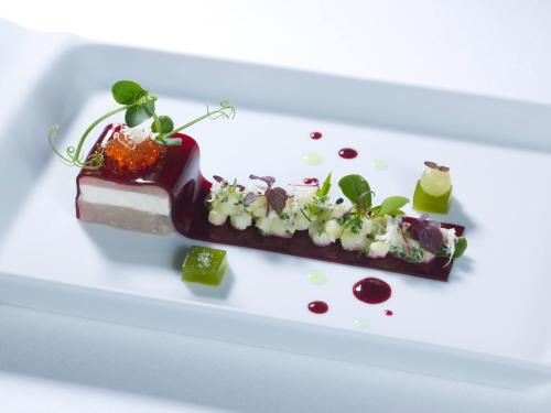 a white plate with a dessert on it at Hotel Elbresidenz an der Therme in Bad Schandau