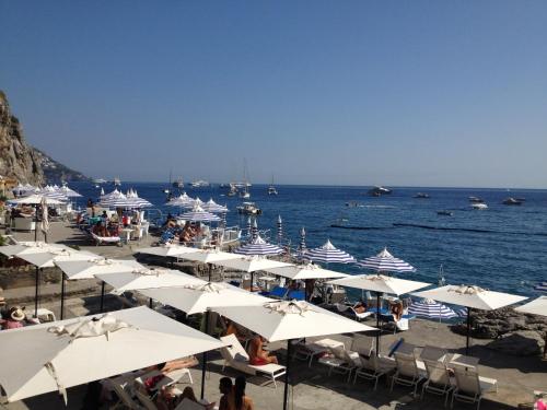 a group of umbrellas on a beach with the ocean at Hotel Marincanto in Positano