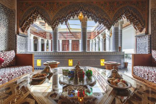 a large room with a glass table in a building at Riad Fes Maya Suite & Spa in Fès