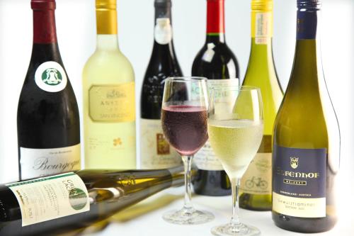 a group of wine bottles and two glasses of wine at Chikurakutei in Minami Aso