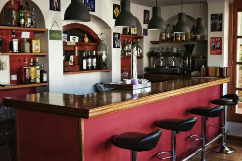 a bar with black stools in a room at Hotel Marbel in Cala Ratjada
