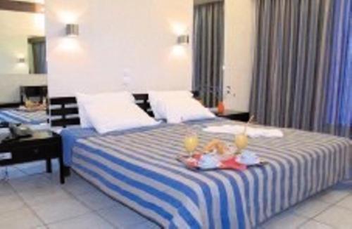 a bedroom with a blue and white bed with candles on it at Violetta in Kamena Vourla