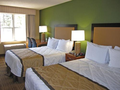 a hotel room with two beds and a window at Extended Stay America Suites - Fort Lauderdale - Cypress Creek - NW 6th Way in Fort Lauderdale