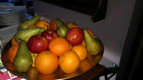 a bowl of fruit with apples oranges and pears at Wasserturm Hotel Mannheim in Mannheim