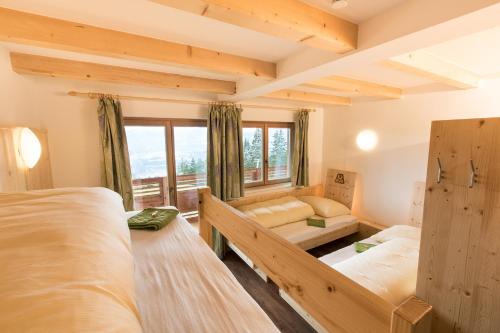 a bedroom with two beds and a window at UALM Untermarkter Alm in Imst