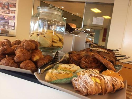a plate of bread and pastries on a table at Hotel Lady Mary in Milano Marittima