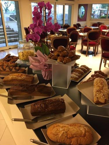 a table with many different types of pastries on it at Hotel Lady Mary in Milano Marittima