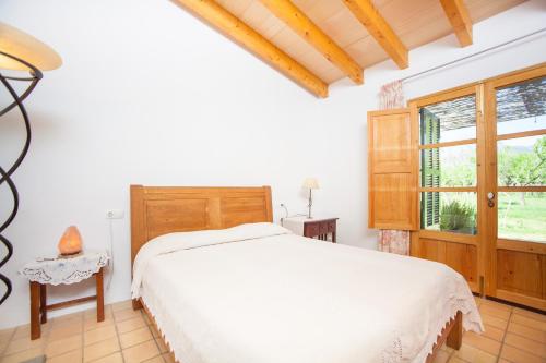 a bedroom with a white bed and a window at Ses Planes - Adults Only ( Ca Na Faustina) in El Port de la Selva