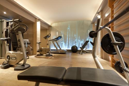 a gym with several exercise equipment in a room at Le Pavillon de la Reine & Spa, Place des Vosges in Paris
