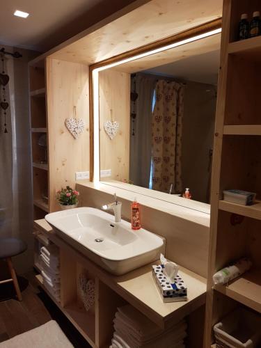 a bathroom with a sink and a mirror at Wiślański Domek z Bajki in Wisła