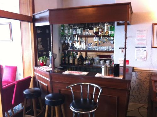 a bar with stools in a restaurant at Howard Hotel in Blackpool