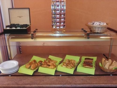 a tray of pastries and other food on a counter at Hôtel du Parc in Salies-du-Salat