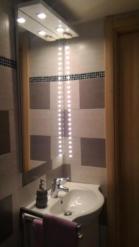 a bathroom with a sink and a mirror at Comodità città-mare Cinque Terre in La Spezia