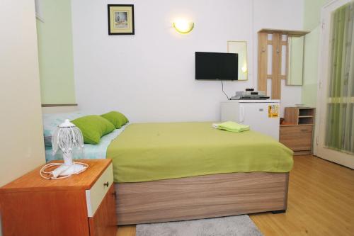 a hotel room with a bed and a television at Apartment Boris in Zadar