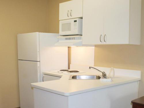 a white kitchen with a sink and a refrigerator at Extended Stay America Suites - Fishkill - Westage Center in Fishkill