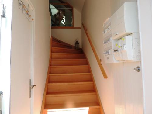 a staircase in a house with wooden floors at le petit Vauquelin in Sommervieu