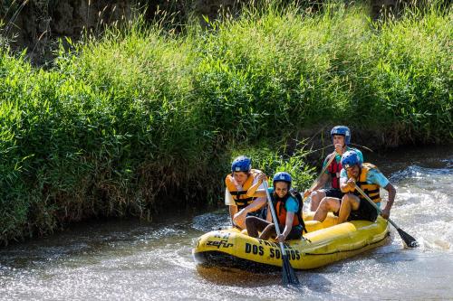 a group of people on a raft in a river at Hotel Fazenda Terra dos Sonhos in Bueno Brandão
