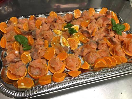 a tray filled with meat and orange slices at Hotel & Restaurant Druidenstein in Trautenstein