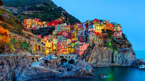 a group of colorful buildings on a mountain at Comodità città-mare Cinque Terre in La Spezia