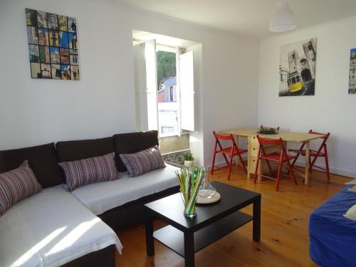 a living room with a couch and a table at Apartments Center Castelo de São Jorge in Lisbon