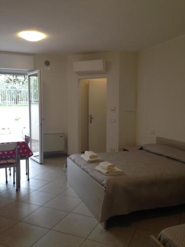 a bedroom with a bed with two towels on it at Casa Armonia in Peschiera del Garda