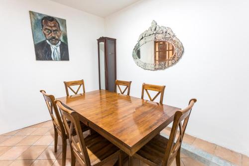 a dining room with a wooden table and chairs at NaNa Vida Hotel Oaxaca in Oaxaca City