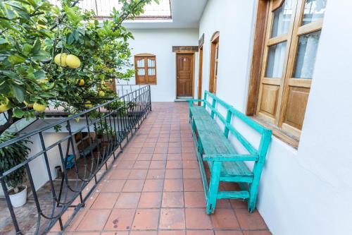 a bench in the courtyard of a house at NaNa Vida Hotel Oaxaca in Oaxaca City