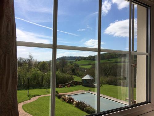 a window looking out at a view of a yard at Sid Valley Country House Hotel in Sidmouth