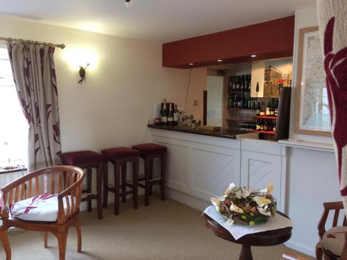 a bar with red stools in a room at Sid Valley Country House Hotel in Sidmouth